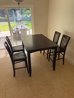 Brown high-top table (36” height) with butterfly leaf and 8 chairs