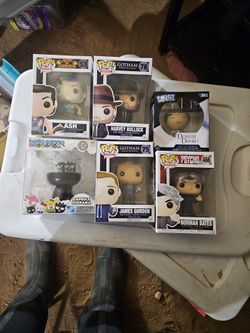 This image features a collection of collectible vinyl figures, including Funko Pop! branded boxes for Gotham characters Harvey Bullock and James Gordo