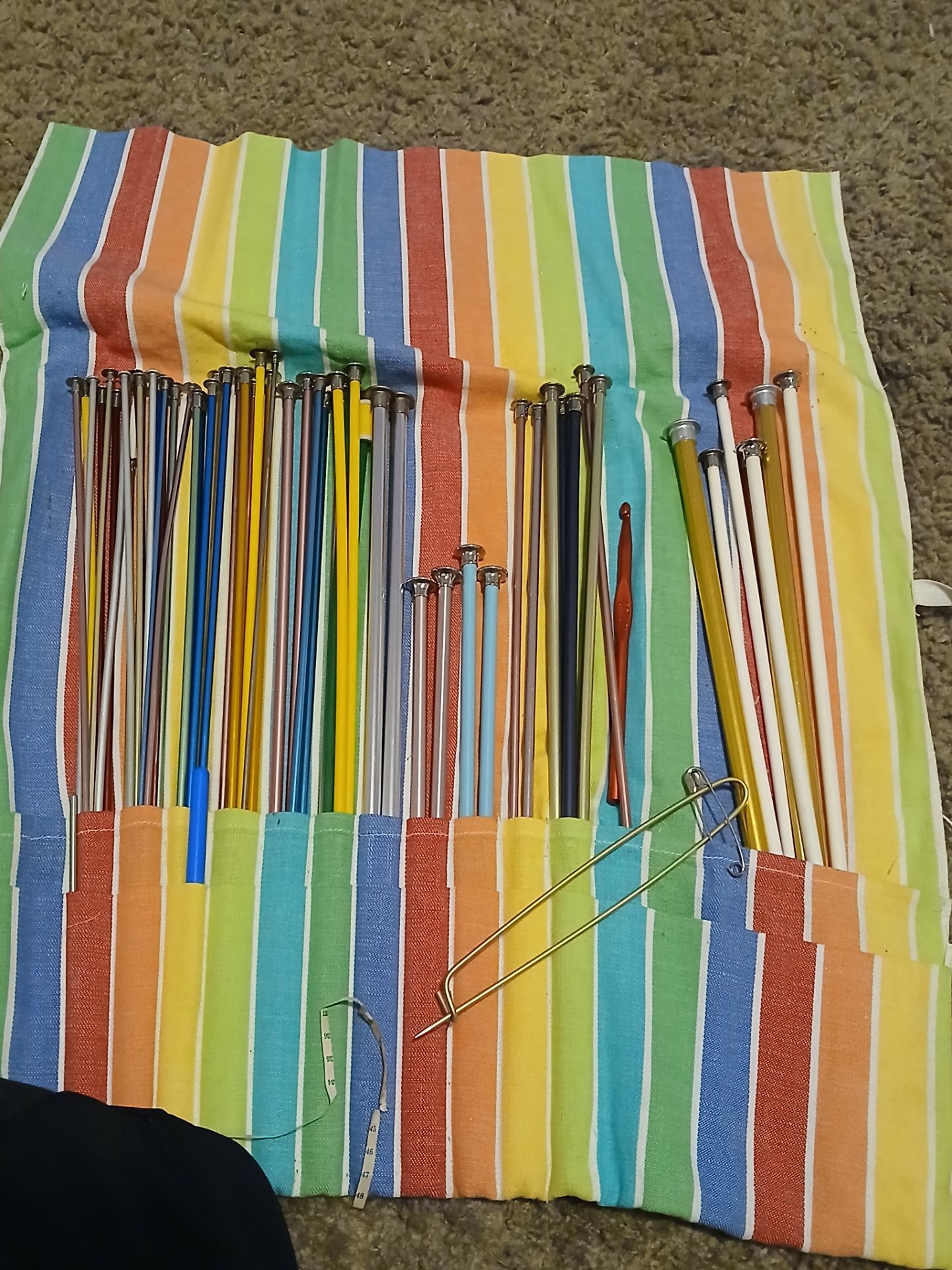 vintage knitting needles set with a colorful striped case.Vintage Knitting