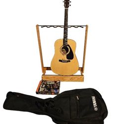 YAMAHA ACOUSTIC GUITAR WITH YAMAHA CASE AND MANY EXTRAS INCLUDING, BRAND NEW CHORD BUDDY, CAPO, 2 GUITAR TUNERS, STRING SWING GUITARS STAND 