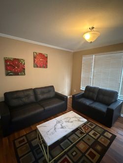 Sofa and love seat all black leather with pull out queen size sofa bed