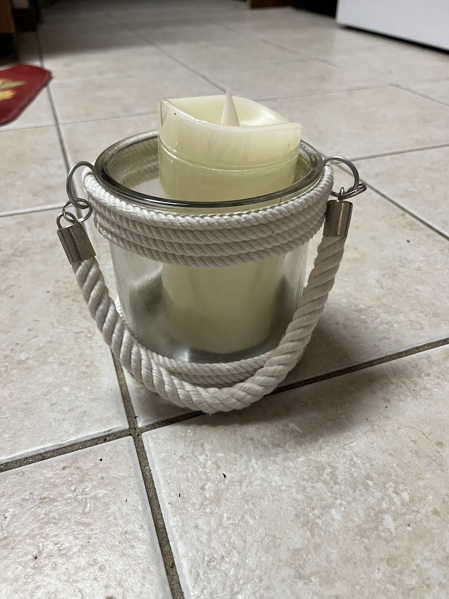 Nautical themed candle holder with line wrapped around the base and the top