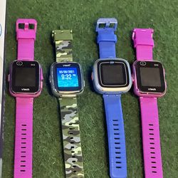 A collection of Vtech Watches and extras