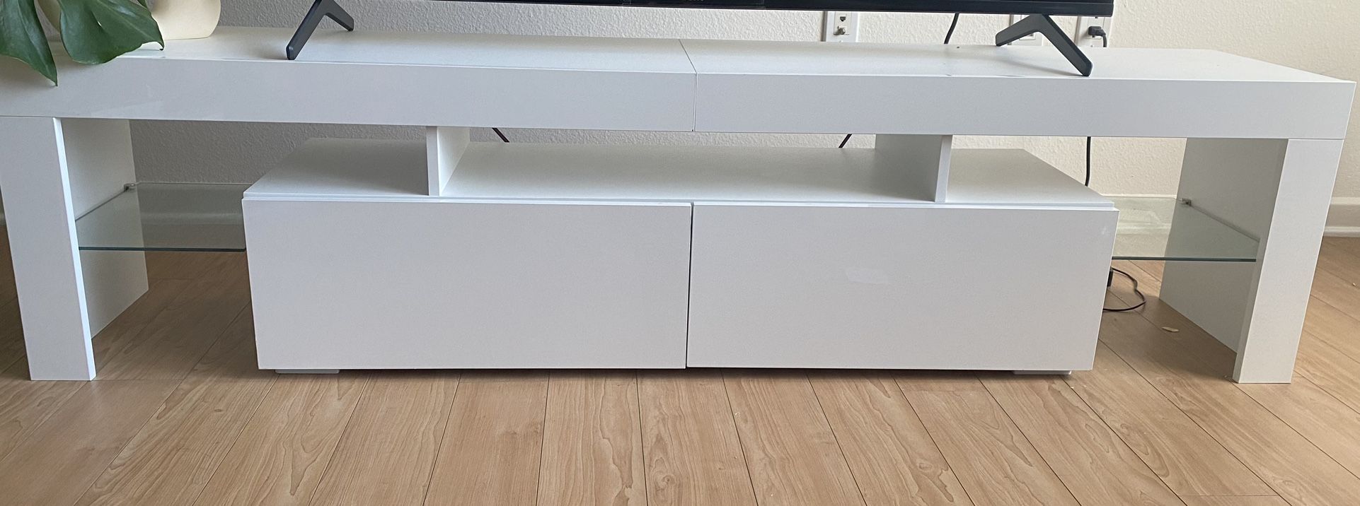 Glossy white TV stand with storage