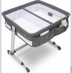 Barely used Simmons Kids By The Bed City Sleeper Bassinet for Twins - Adjustable Height Portable Crib with Wheels & Airflow Mesh!