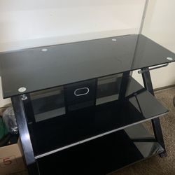 Steel TV table with black glass shelves