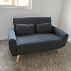 small couch w 2 pillows 