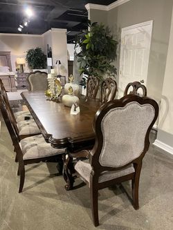 Brown finish dining set features large dining table w/2 extension leaf