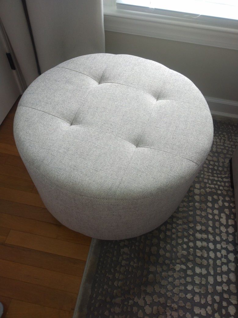 gray tweed swiveling tufted round ottoman

