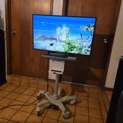 Samsung 40Inch. Smart  TV With Rolling  Stand Up Adjustable On Wheels Mobile Cart  Desk 