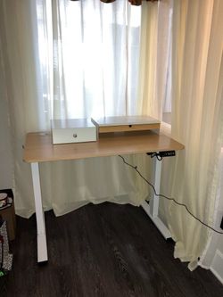 Height adjustable standing desk with additional desk drawers