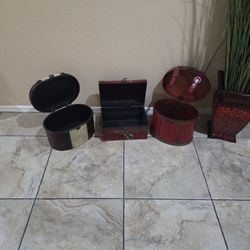 These are a set of decorative, vintage-style wooden storage or trinket boxes. 