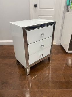 Sleek White Nightstand with Mirrored Trim and Crystal Knobs