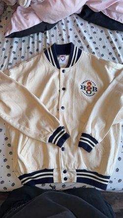 This is a vintage House of Blues 25th Anniversary varsity jacket featuring cream corduroy and navy blue striped ribbed trim