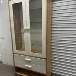 IKEA Tunhem vitrine tall storage cabinet featuring double glass doors and two lower drawers