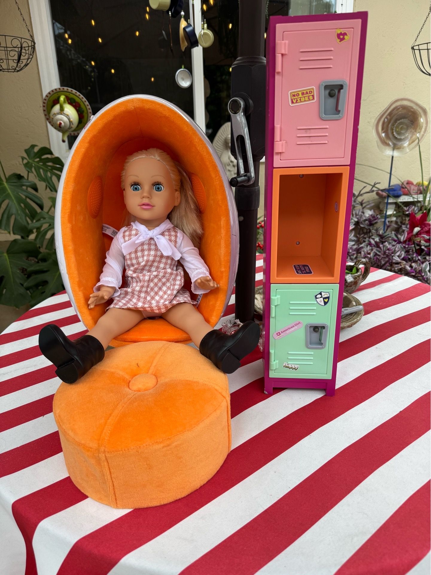 American girl doll with egg chair/ottoman and locker.