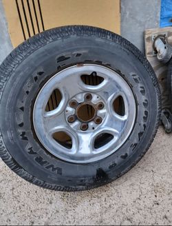 Goodyear Wrangler ST Tire on Chrome Wheel
