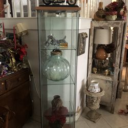 Lighted showcase  with moveable glass shelves .