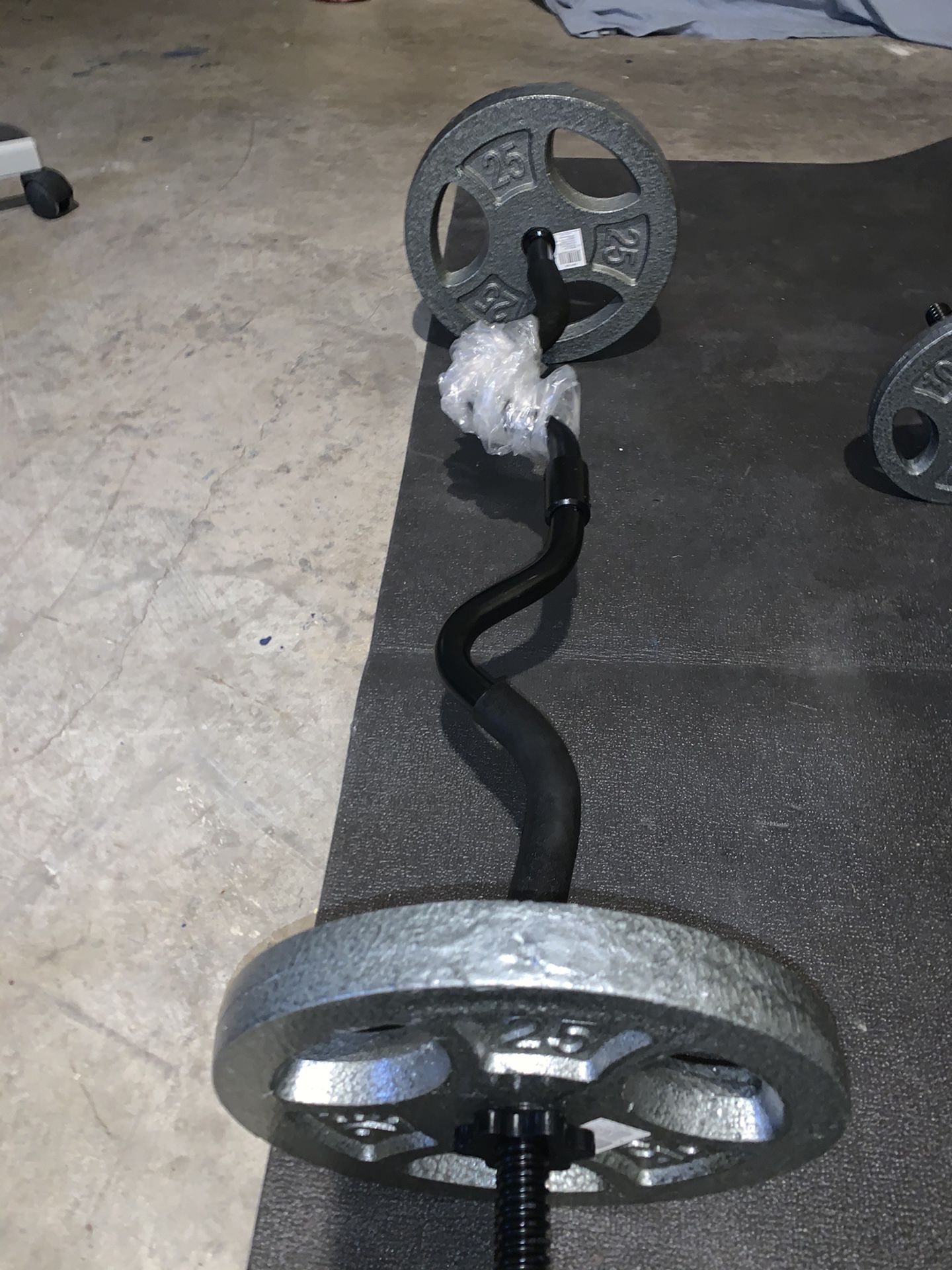 NEW Curl Bar with 2 New 25 lbs Iron Weight Plates.