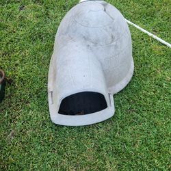 Large igloo style dog house with heat light for cold days .