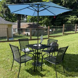 metal patio set, complete and ready to use, includes four chairs, table, umbrella and stand! The umbrella is new, never used, everything looks like ne
