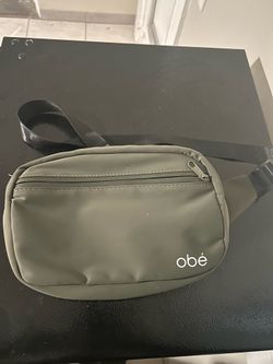 olive green Obé Fitness waist pack/belt bag featuring a white logo