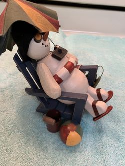 Snowman on vacation at the beach
