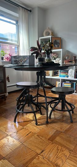 Height adjustable round dining table with four matching stools