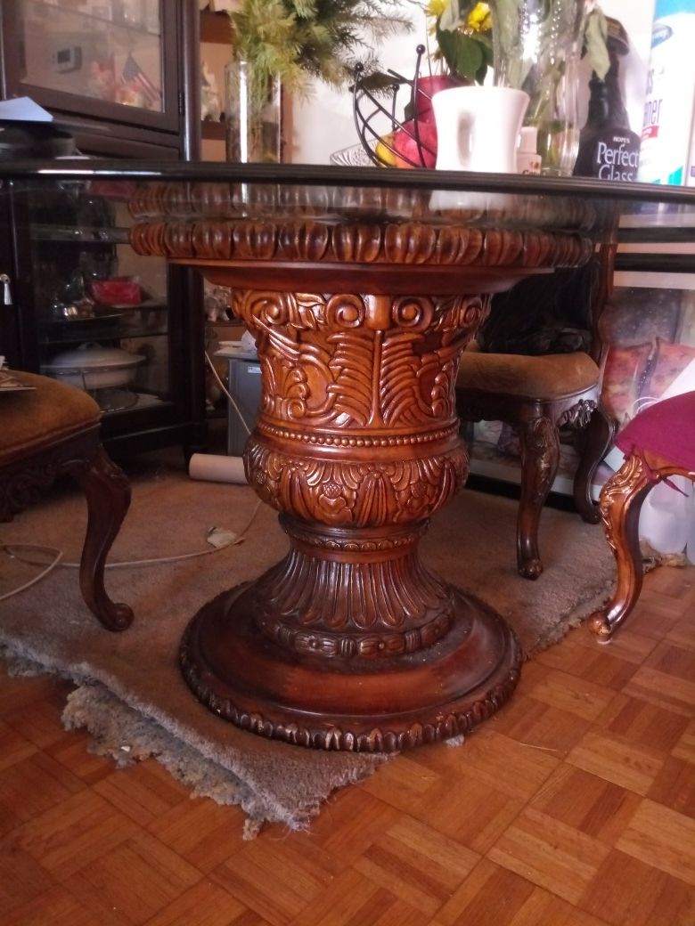 Gorgeous Wooden pedestal round glass top dining table with chairs