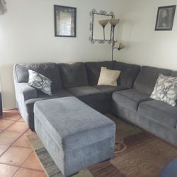 Sectional bluish grey sofa with ottoman & 2 pillows