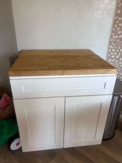 white cabinet with butcher block