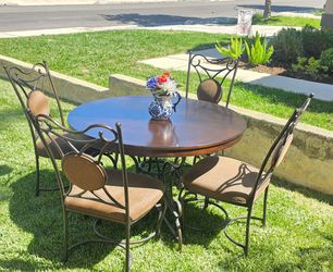 Dark wood round table seats 4