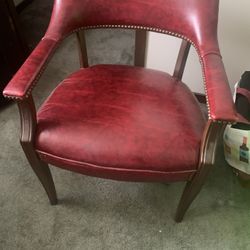 Two Burgundy captain's guest a armchair with brass nailhead trim and a mahogany-finish wood frame 