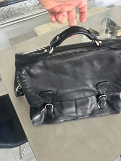 Kenneth Cole Leather laptop briefcase in black.  High-quality leather with fabric lining and silver hardware