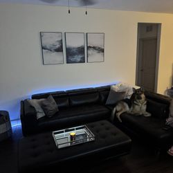 black leather sectional with ottoman .