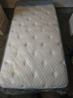 Twin Pillowtop bed in like new condition, box spring and frame.  Jewlery, Clock, bottle,  light bulb and microbe