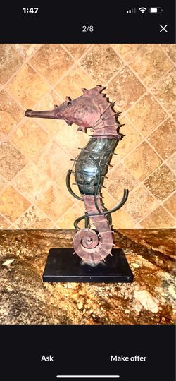Metal seahorse with glass body. Head opens up for tea light insert. Sits on a metal plate. Hand made. For indoor or outdoor. See pics for measurements