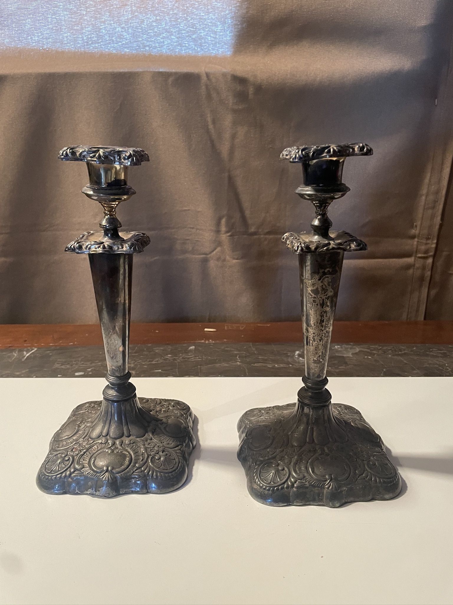 Vintage set of 2 silverplate pillar candle holders stands at 10 inches tall, adding a touch of elegance to any space.