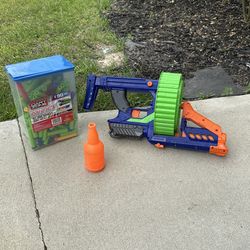 Nerf blaster with drum magazine + large dart refill set.