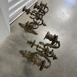 Ornate antique French-style brass wall sconces with multiple candle arms. Wall sconces have been used for centuries to provide ambient lighting, evolv