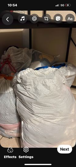 Lots Of Bags Full Of Women Clothes