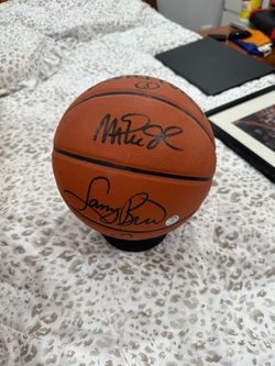 Signed Larry bird and Magic Johnson basketball
