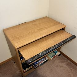 wheeled table with storage shelves and a rolling keyboard platform