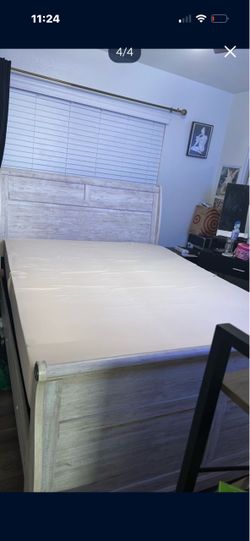 Queen sized wood bed set frame headboard, mattress and footboard.