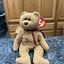 Ty Beanie “Curly”  The Bear 1996 Retired Plush Toy.  Brand new with tags.  Had been on display with a Ty Beanie Babie Collection.  