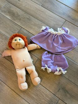vintage Cabbage Patch Kids doll with red yarn hair, green eyes
