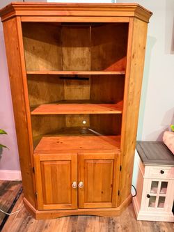solid pine wood corner hutch with clear faceted glass door knobs.