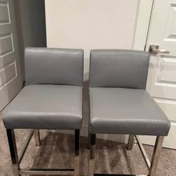 2 leather chairs with chrome legs