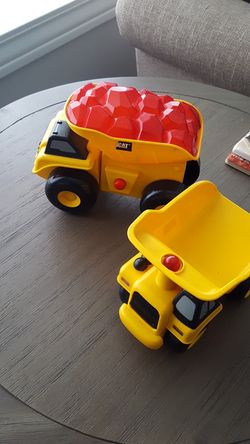2 battery operated CAT trucks