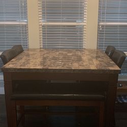 Dining room table with 6 chairs and a bench